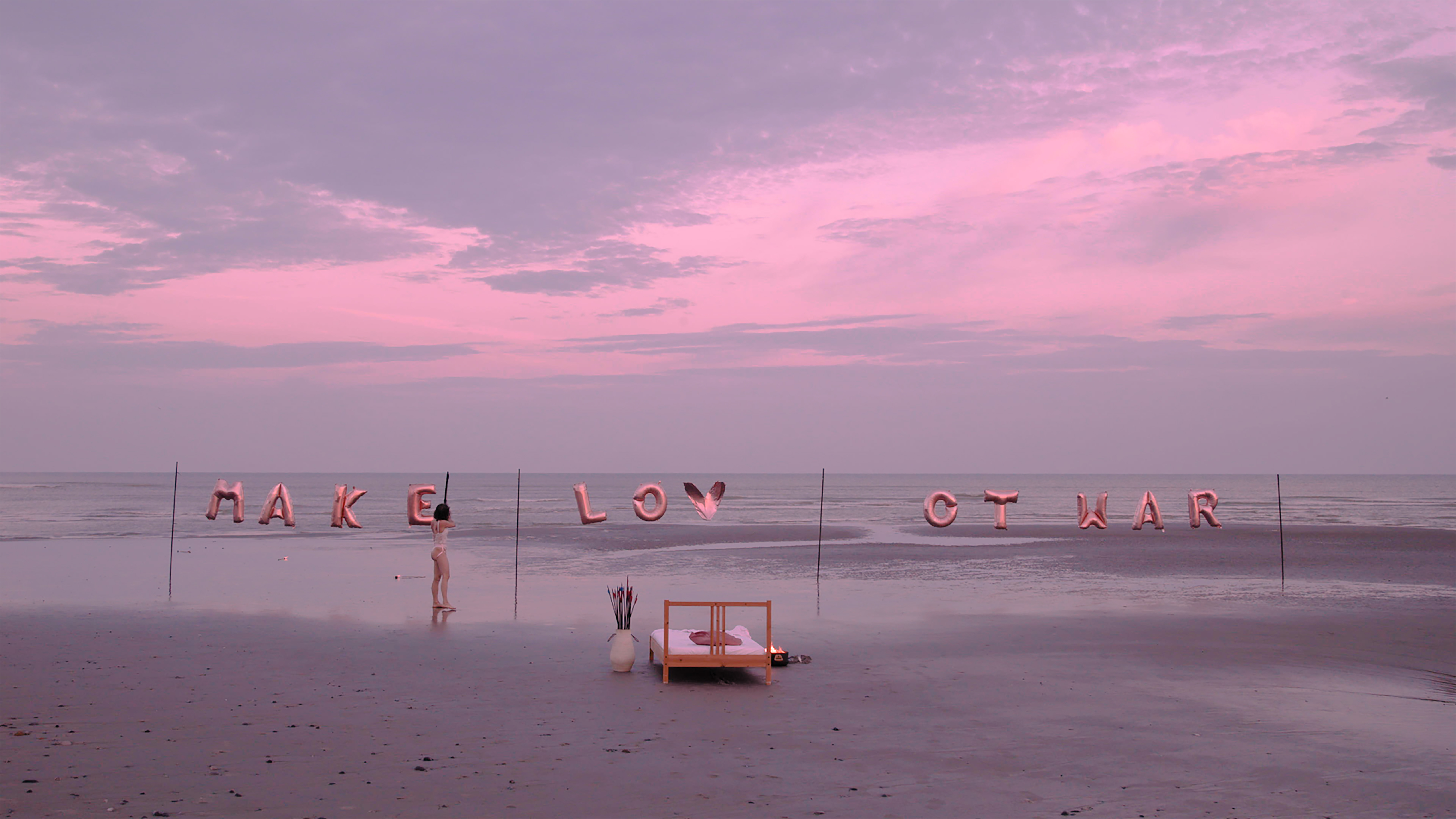 Make Love Not War — figure walking on the beach